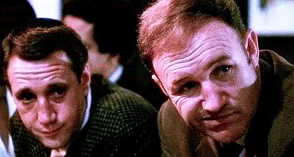 Jimmy "Popeye" Doyle (Gene Hackman) and Buddy "Cloudy" Russo (Roy Scheider) take in the scene at the Copacabana in The French Connection (1971), 20th Century Studios