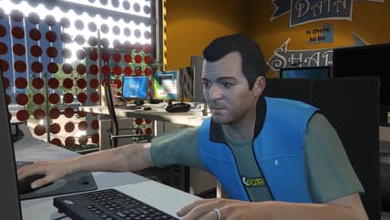 Michael De Santa (Ned Luke) tries to fix a computer in Grand Theft Auto V (2013), Rockstar Games