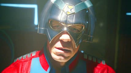 Peacemaker (John Cena) can hear the Justice Gang mocking him thanks to some faulty A/V wiring in Peacemaker Season 2 Episode 1 "The Ties That Grind" (2025), DC Studios