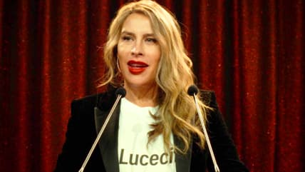 Emilia (Karla Sofía Gascón) speaks about the goals of her La Lucecita charity in Emilia Pérez (2024), Netflix