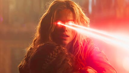 Supergirl (Milly Alcock) uses heat vision to defend Ruthye (Eve Ridley) in Supergirl (2026), DC