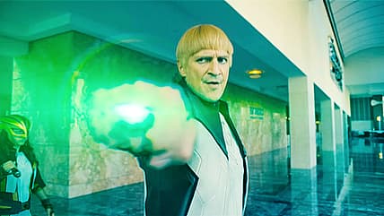 Guy Gardner/Green Lantern (Nathan Fillion) blocks an angry mob from Superman's view in Superman