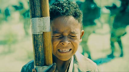 Young Jarhanpurian boy saved by Guy Gardner (Nathan Fillion) in Superman (2025), DC Studios