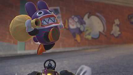 Nabbit (Dawn M. Bennett) drives past graffiti of himself in Mario Kart World (2025), Nintendo