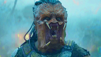 Dek (Dimitrius Schuster-Koloamatangi) roars in defiance of the planet Genna's killer fauna in Predator: Badlands (2025), 20th Century Studios