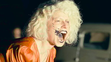 The Bride (Jessie Buckley) roars defiantly against the police in The Bride! (2026), Warner Bros. Pictures