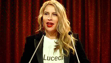 Emilia (Karla Sofía Gascón) speaks about the goals of her La Lucecita charity in Emilia Pérez (2024), Netflix