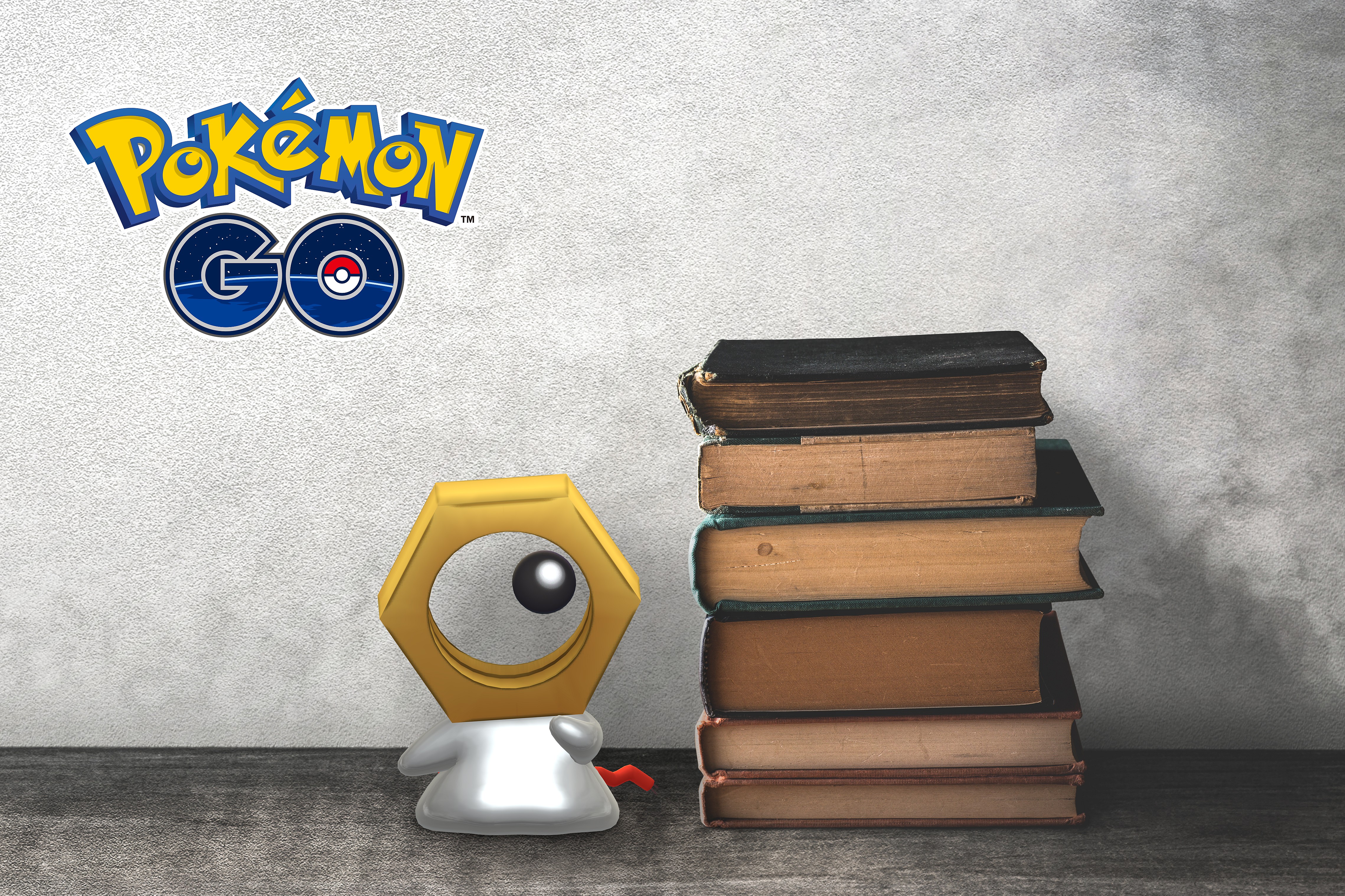 Meltan eyeballs a pile of old books in Pokémon GO (2016), Niantic