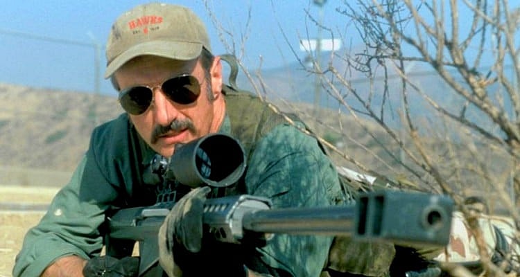 Michael Gross as Burt Gummer with rifle