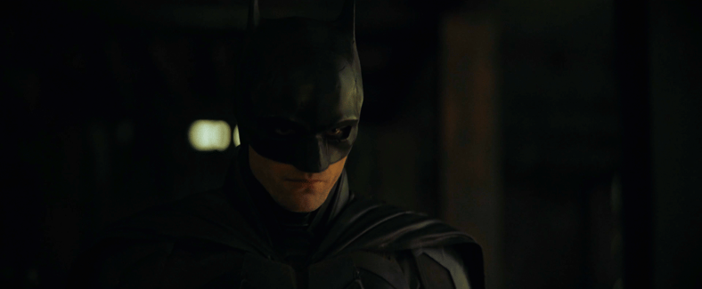 Batman (Robert Pattinson) and Jim Gordon (Jeffrey Wright) interrogate William Kenzie (Peter
