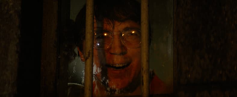 The Riddler (Paul Dano) watches as his plan unfolds in The Batman (2022) via Warner Bros. Pictures