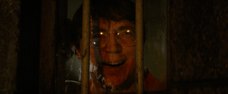 The Riddler (Paul Dano) watches as his plan unfolds in The Batman (2022) via Warner Bros. Pictures