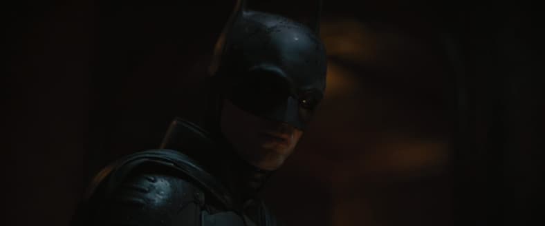 Batman (Robert Pattinson) solves The Riddler's (Paul Dano) first riddle in The Batman (2022), Warner Bros. Pictures