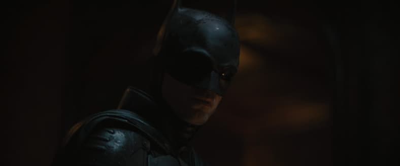 Batman (Robert Pattinson) solves The Riddler's (Paul Dano) first riddle in The Batman (2022)