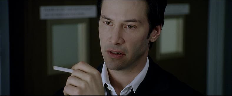 John Constantine (Keanu Reeves) receives grave news about his vice in Constantine (2005), Warner