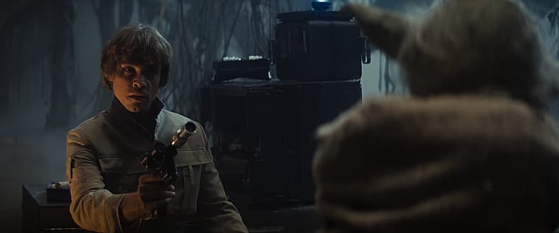 Luke Skywalker points his blaster at a Dagobah local in Star Wars Episode V: The Empire Strikes