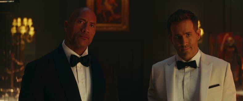 Dwayne Johnson as John Hartley and Ryan Reynolds as Nolan Booth in Red Notice, Netflix