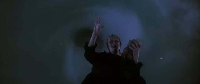 Frankenstein's Monster (Tom Noonan) waves goodbye before being sucked into limbo in The Monster Squad (1987), TriStar Pictures 