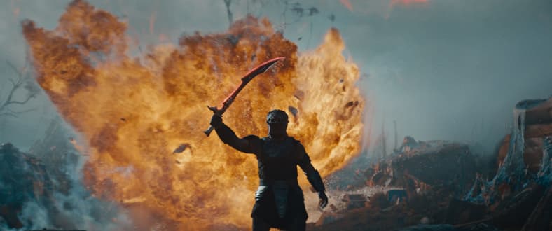 Dek (Dimitrius Schuster-Koloamatangi) raises his blade in Predator: Badlands (2025), 20th Century Studios