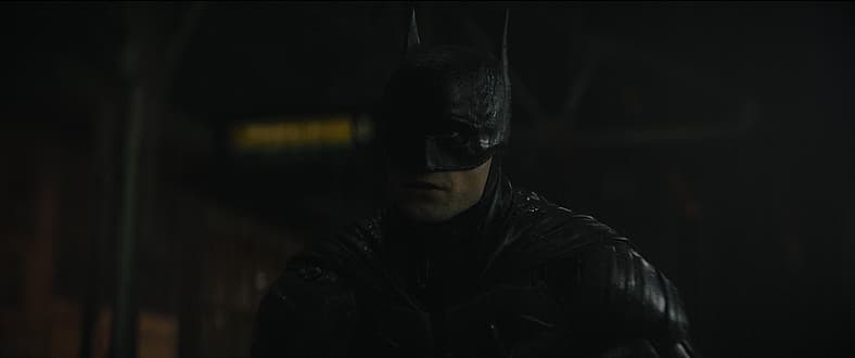 Batman (Robert Pattinson) reveals himself to a robbery gang in The Batman (2022), Warner Bros