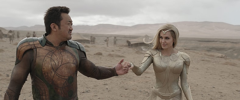 (L-R): Gilgamesh (Don Lee) and Thena (Angelina Jolie) in Marvel Studios' ETERNALS. Photo courtesy of Marvel Studios. ©Marvel Studios 2021. All Rights Reserved.