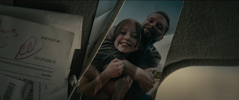 Father (Jack Reynor) and daughter (Emily Mitchell) wrapped up in happier times in Lee Cronin's The Mummy (2026), New Line Cinema