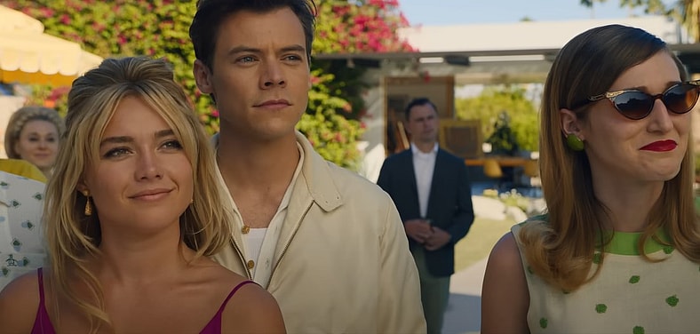 Alice (Florence Pugh), Jack Chambers (Harry Styles, and Bunny (Olivia Wilde) at a company party in Don't Worry Darling, 2022, Warner Bros