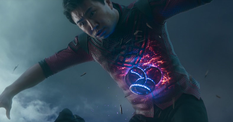 Shang-Chi (Simu Liu) feels the full force of Wenwu's control over the Marvel Cinematic Universe's version of the Ten Rings in Shang-Chi and the Legend of the Ten Rings (2021), Marvel Entertainment via Blu-Ray