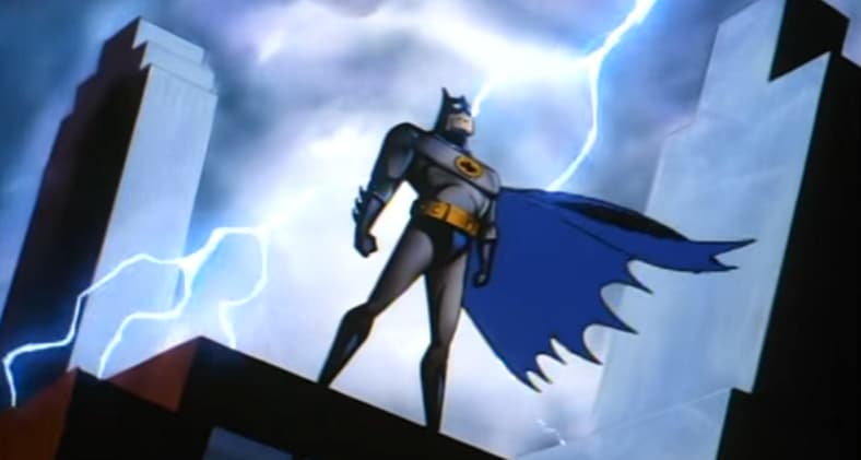 Batman stands on a rooftop, illuminated by lightning in Batman: The Animated Series (1992), Warner