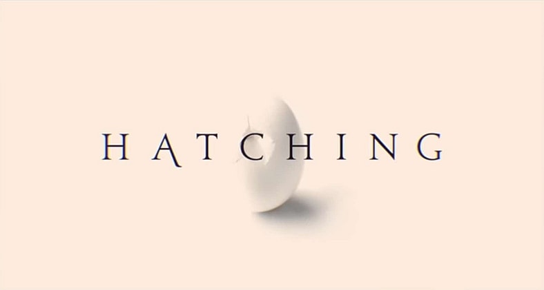A hard-boiled opening title in Hatching (2022), Nordisk Film 