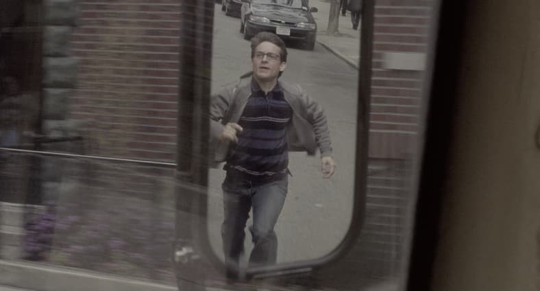 Peter Parker (Tobey Maguire) tries to catch up to his school bus in Spider-Man (2002), Marvel Entertainment