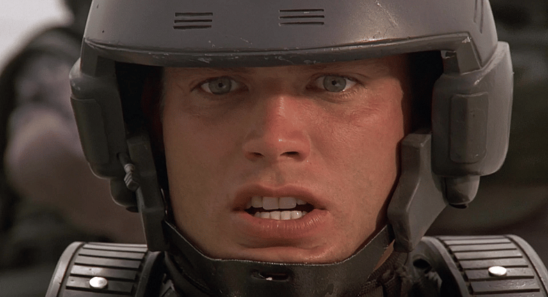 Johnny (Casper Van Dien) realizes his friendly-fire was fatal in Starship Troopers (1997), Tri-Star