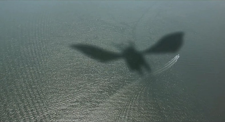 Ghidorah casts a long shadow over the ocean in Godzilla vs. King Ghidorah (1991), Toho Co. Ltd.