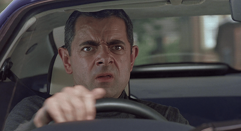 Johnny English (Rowan Atkinson) drives the Aston Martin DB7 Vantage in Johnny English (2003)
