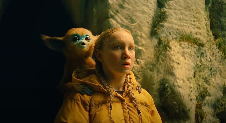 Yuri (Helena Zengel) carrying baby Ochi on her shoulder in The Legend of Ochi (2025), AGBO