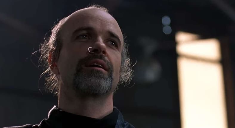 Despite the attempt on his life, Cain (Tom Noonan) forgives an offscreen Alex Murphy (Peter Weller) in RoboCop 2 (1990), Orion Pictures
