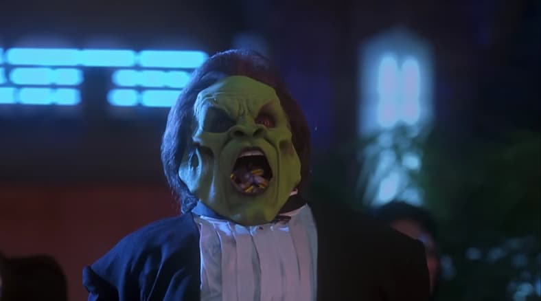 Most people sweat bullets, but Dorian Tyrell (Peter Greene) with his Big Head spits bullets in The Mask (1994), New Line Cinema