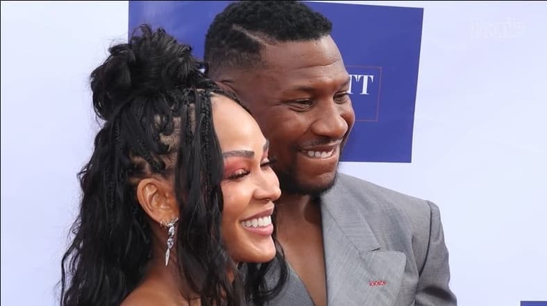 Meagan Good and Jonathan Majors pictured smiling in a photo gallery by People Magazine, July 10, 2024 via YouTube