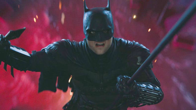 Batman (Robert Pattinson) narrowly escapes The Riddler's (Paul Dano) attempt to drown him in The Batman (2022), Warner Bros. Pictures