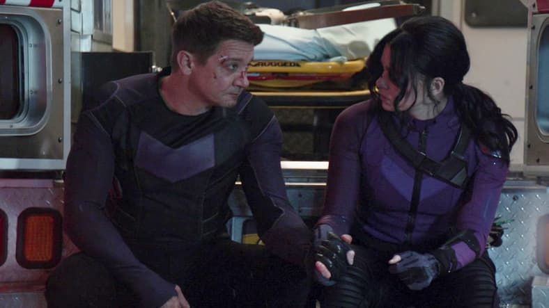 Clint (Jeremy Renner) and Kate (Haliee Steinfeld) take a breather after a well-earned victory in Hawkeye Episode 6 "So This Is Christmas?" (2021), Marvel Entertainment