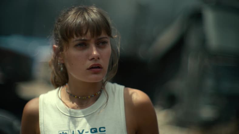 Kate (Ella Purnell) watches on as the team encounters the Alpha Queen (Athena Perample) in Army of the Dead (2021), Netflix