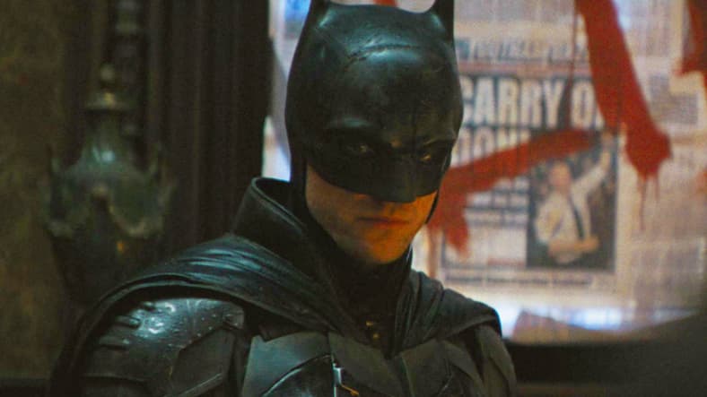 Batman (Robert Pattinson) investigates The Riddler's (Paul Dano) latest murder in The Batman (2022), Warner Bros. Pictures