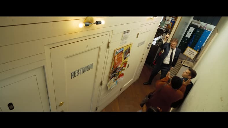 Frank Drebin Jr. (Liam Neeson) requests to use the restroom in The Naked Gun (2025), Paramount Pictures