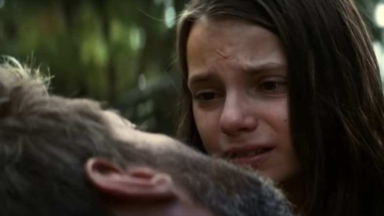 X-23/Laura Kinney (Dafne Keen) crying over Logan (Hugh Jackman) as he dies in Logan, 2017, 20th Century Fox