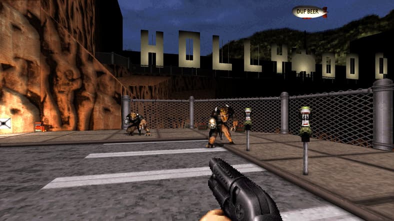 Duke Nukem (Jon St. John) fights aliens in front of the Hollywood sign in Duke Nukem 3D: 20th Anniversary Edition World Tour (2016), Gearbox Publishing