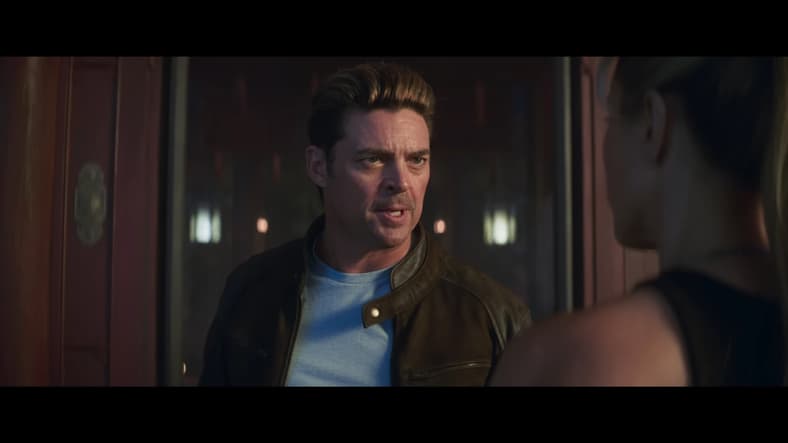 Johnny Cage (Karl Urban) insists that Sonya (Jessica McNamee) placed her bets on the wrong champion in Mortal Kombat II (2025), Warner Bros. Entertainment