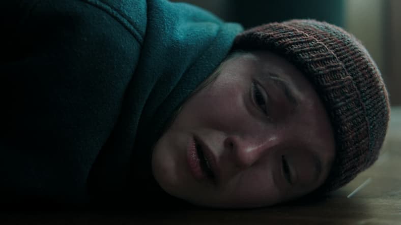 Ellie (Bella Ramsey) watches on powerless as Joel (Pedro Pascal) succumbs to his wounds in The Last of Us Season 2 Episode 2 "Through the Valley" (2025), HBO