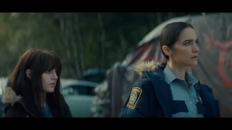 Martha Cypress (Romy Weltman) and Dana Cypress (Melanie Scrofano) watching Blaine Abel (Steven Ogg) preaching about the Revivers in Revival Season 1 Episode 4 "Run Along Little Lamb" (2025), Syfy