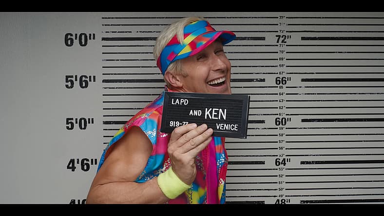 Ken (Ryan Gosling) takes his mugshot in Barbie (2023), Warner Bros. Pictures
