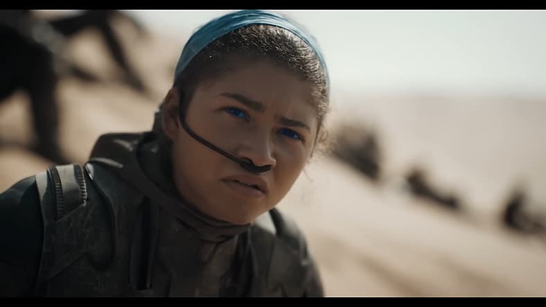 Chani (Zendaya) watches on as Paul (Timothée Chalamet) proves himself to the Fremen in Dune: Part